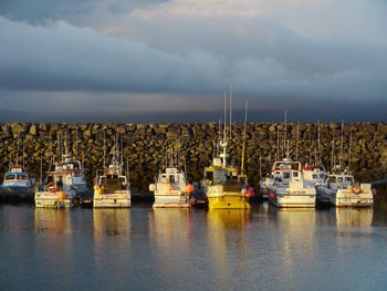 Boats moored in lake against sky