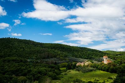 Scenic view of trees and buildings against sky