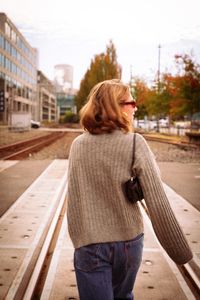Rear view of woman walking on street