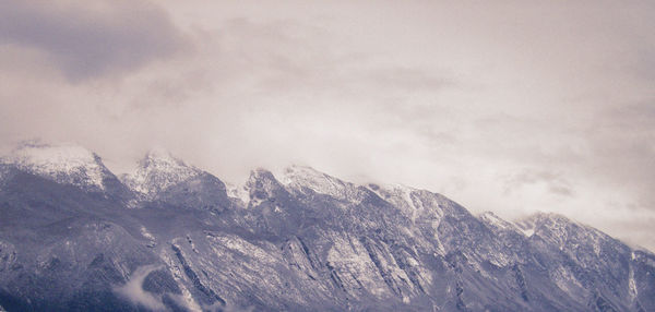 Close-up of snow on mountain against sky