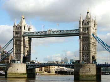 Tower bridge over thames river against sky in city