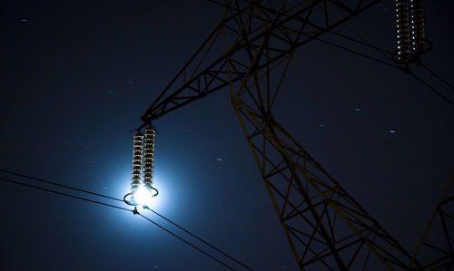 Low angle view of electricity pylon against sky