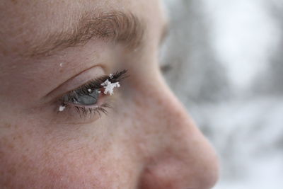 Close-up of teenage girl with snow on eyebrow