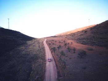 Road by mountain against clear sky