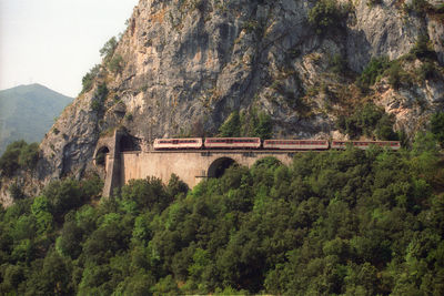 Passenger train in galerie of rocky mountain range on the way to ajaccio.