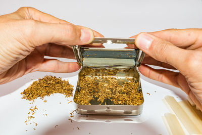 Midsection of person holding ice cream on table