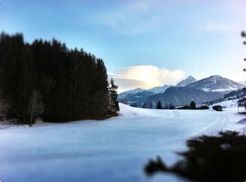 Scenic view of snow covered mountains against sky