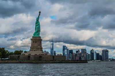 Statue of buildings against cloudy sky