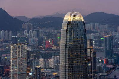 Illuminated buildings in city against sky