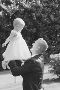 Close-up of happy father lifting daughter