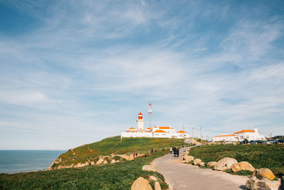 Lighthouse against cloudy sky