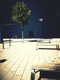 Empty bench on table by sidewalk