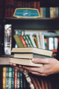 Cropped image of men holding book