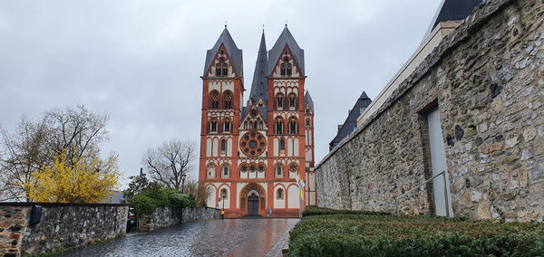 Low angle view of cathedral amidst buildings against sky