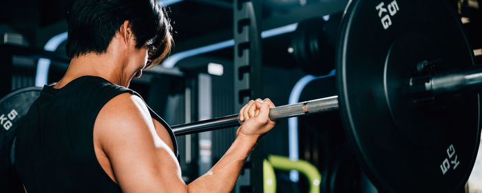 Side view of woman exercising in gym