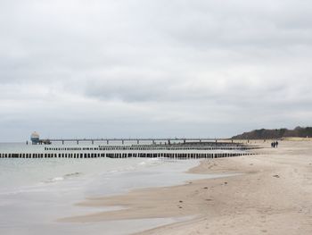 View of beach against cloudy sky