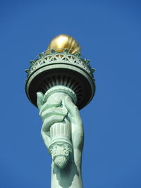 Low angle view of statue against blue sky