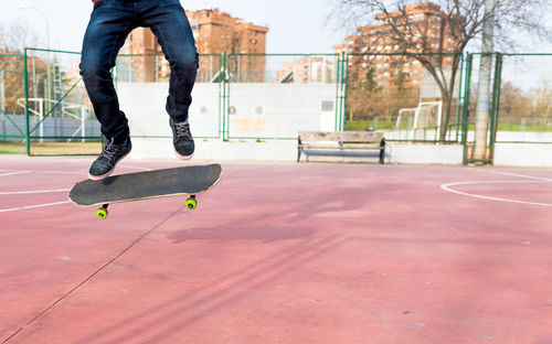 Low section of person skateboarding at park