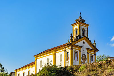 Low angle view of building against clear blue sky