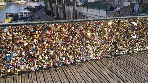 Close-up of padlocks on railing against bridge