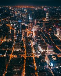 High angle view of illuminated buildings in city at night