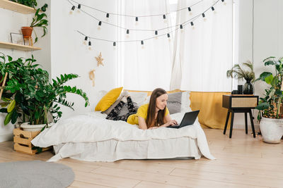 Young woman lying on floor at home