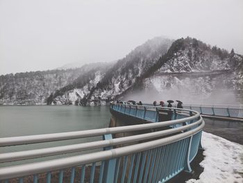Scenic view of river against mountains during winter