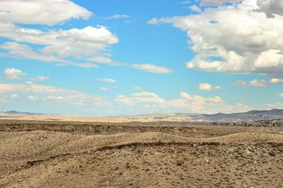 Scenic view of landscape against cloudy sky