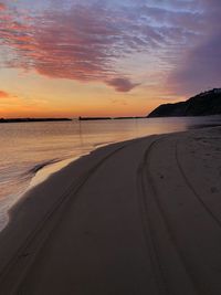 Scenic view of beach against sky during sunset