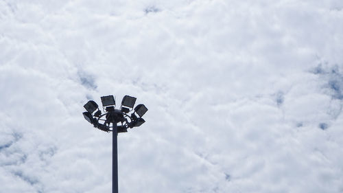 Low angle view of street light against cloudy sky