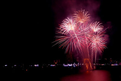 Stunning fireworks splashing in the night sky over the city harbor