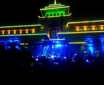 Group of people in illuminated building at night