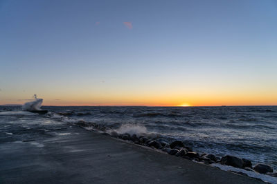 Scenic view of sea against clear sky during sunset