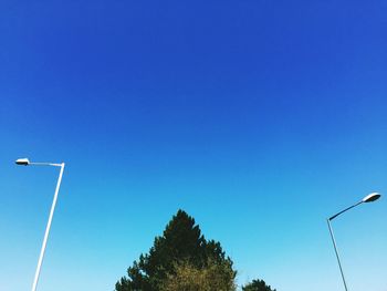 Low angle view of street light against blue sky