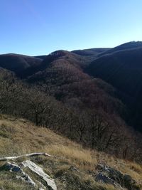 Scenic view of mountains against clear blue sky