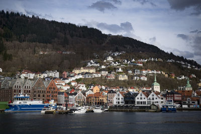 High angle view of townscape by sea against sky
