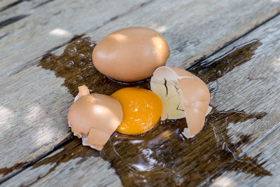 High angle view of broken eggs on table