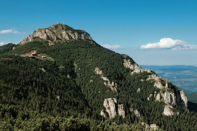Scenic view of mountain against blue sky