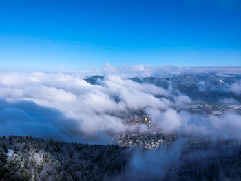 Aerial view of mountains against blue sky