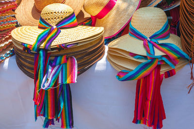 Stacked sun hats for sale at market stall