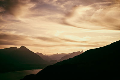 Scenic view of silhouette mountains against sky at sunset