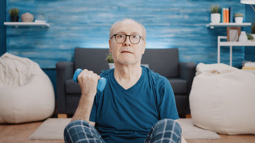 Low angle view of young woman sitting at home