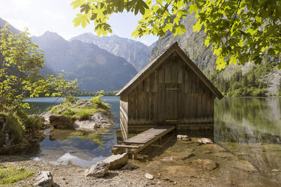 House by lake against mountain