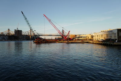 Machinery in sea against clear sky