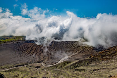 Scenic view on volcanic landscape, clouds in aso crater, aso town in kyushu, japan