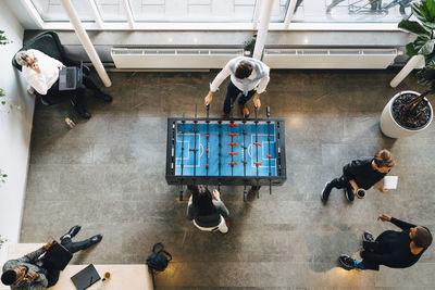 Directly above shot of business people taking break after office work