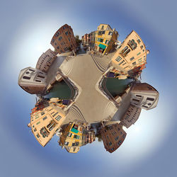 Little townhouse planet against blue sky