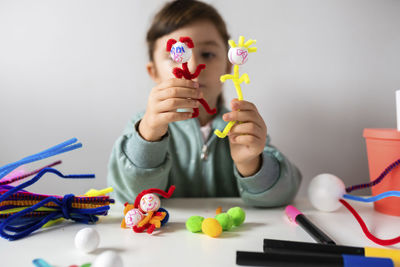 Boy playing with toy toys on table