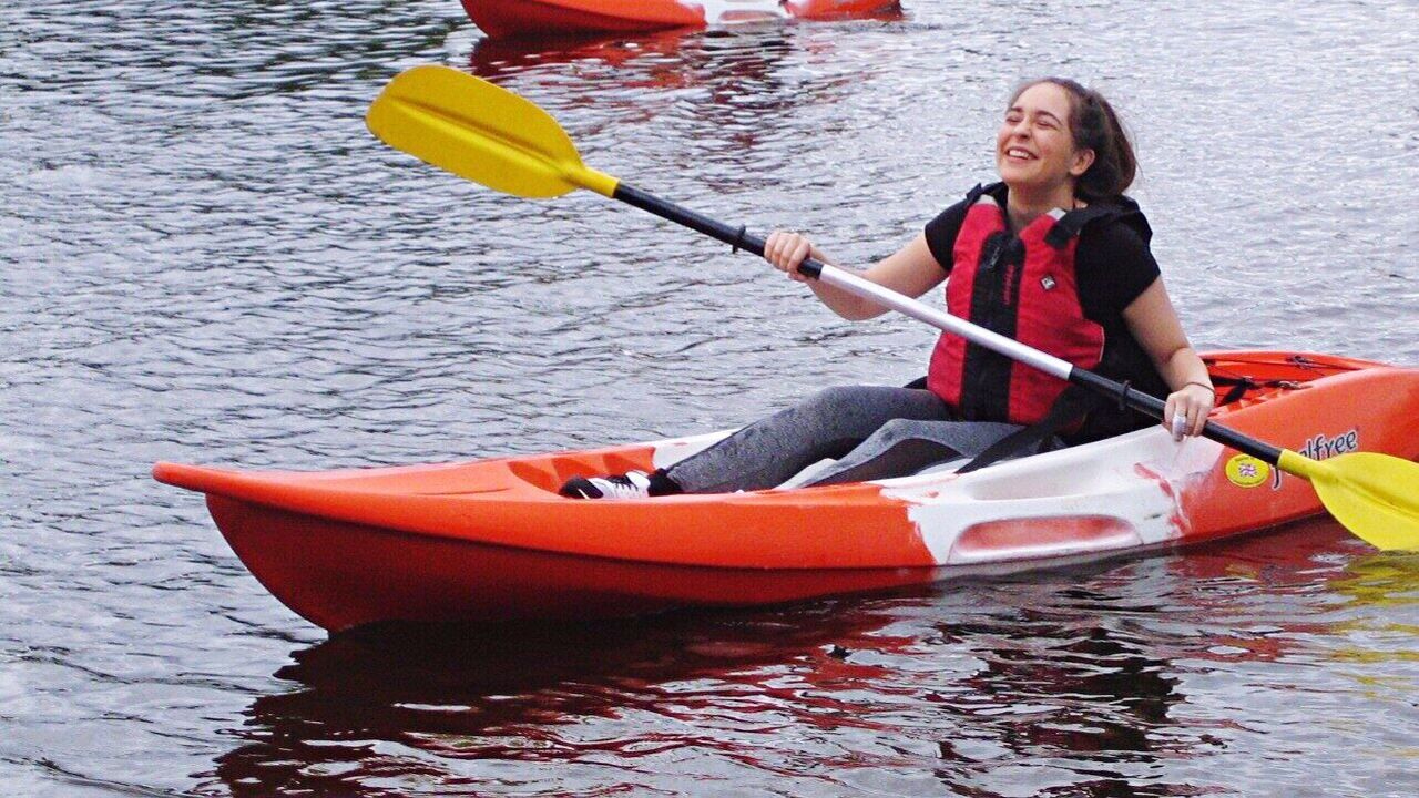 kayak, oar, adult, one person, nautical vessel, adults only, life jacket, sport, smiling, aquatic sport, people, summer, one woman only, water, young adult, outdoors, close-up, rowing, day