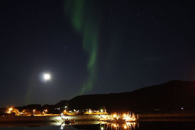 Scenic view of lake against sky at night
